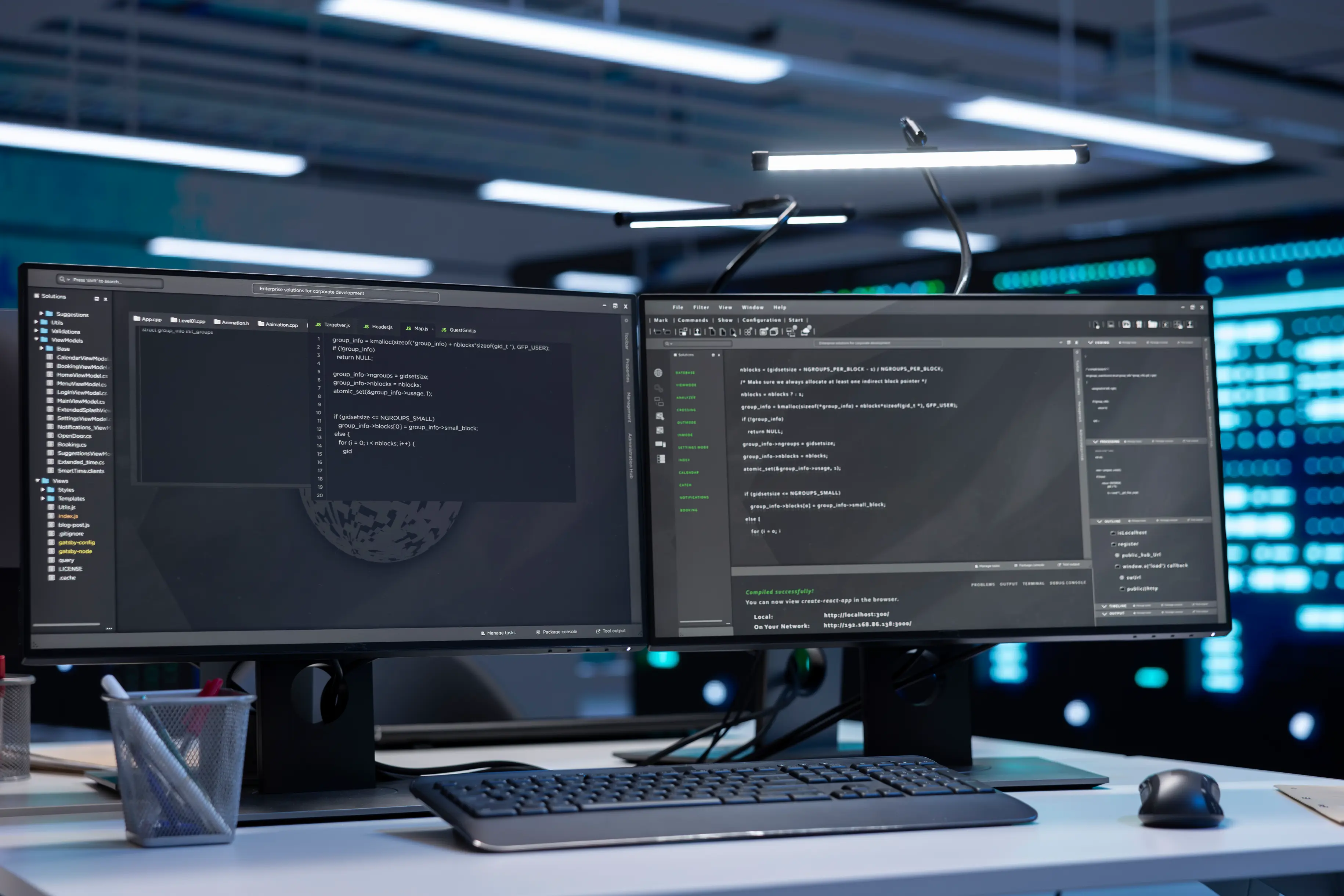 Dual monitors showing code in a data center, close-up